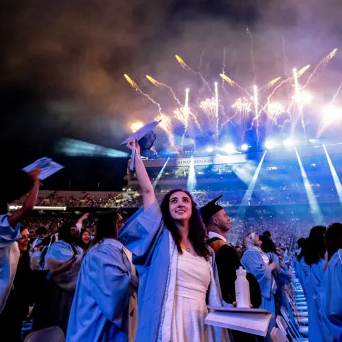 First generation graduate and Carolina Covenant Scholar celebrates with her fellow graduates at the UNC-Chapel Hill Spring Commencement 2024.
