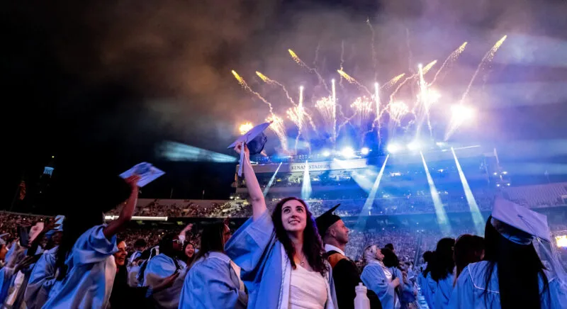First generation graduate and Carolina Covenant Scholar celebrates with her fellow graduates at the UNC-Chapel Hill Spring Commencement 2024.
