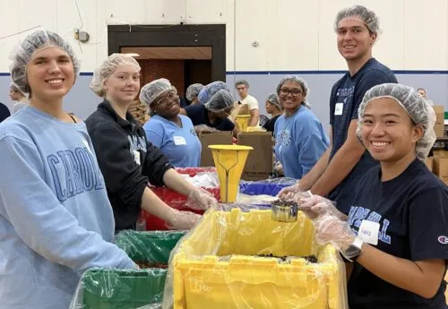 Carolina students volunteering by packing food