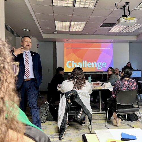 A UNC classroom with a speaker in front of students sitting and listening.