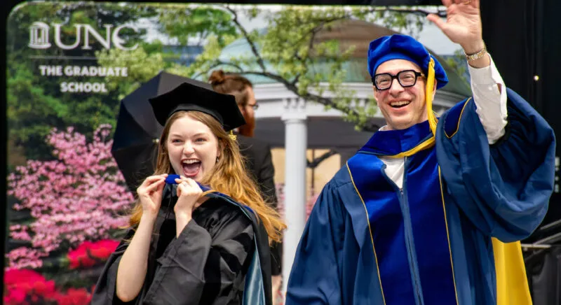 Professor and graduate student at commencement ceremony.
