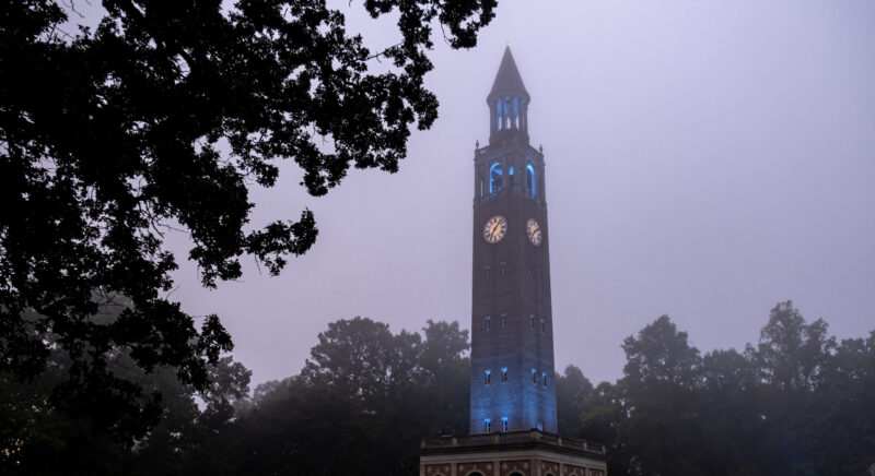 The Bell Tower surrounded by trees on a foggy morning.