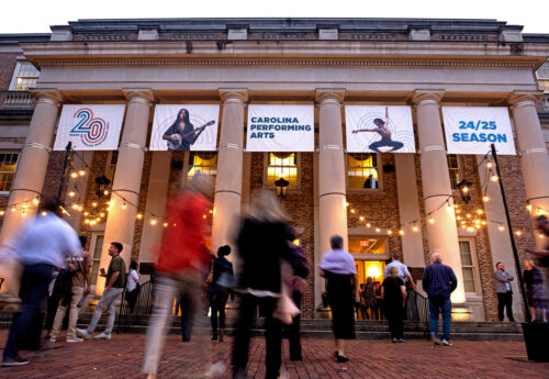 Carolina performing arts building with guests (out of focus) walking inside