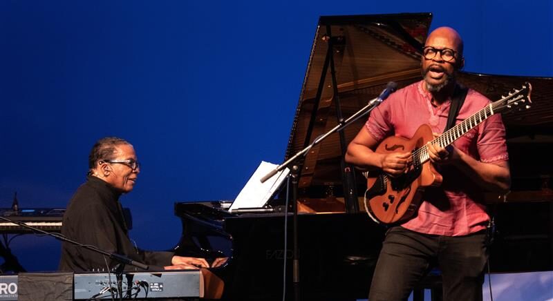 Guitarist and pianist performing on stage