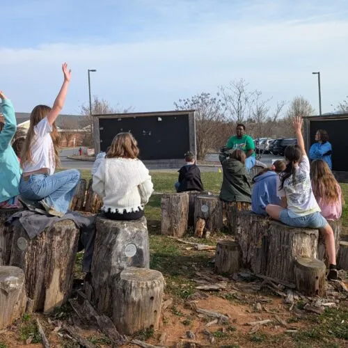 Students and teachers in outdoor education classroom.