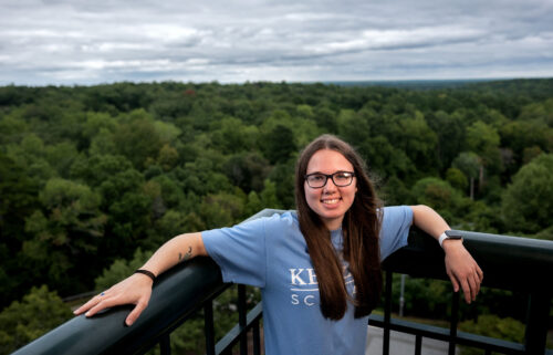 Kessler Scholar Emily Shipley standing outside with trees and skies behind her in the background