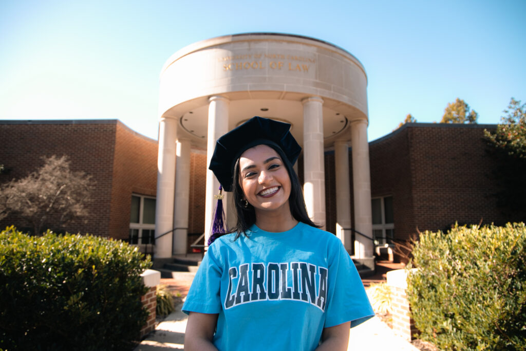 UNC Law Student outside of the building in her graduation cap.