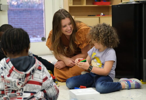 Teacher interacts with K-5 student