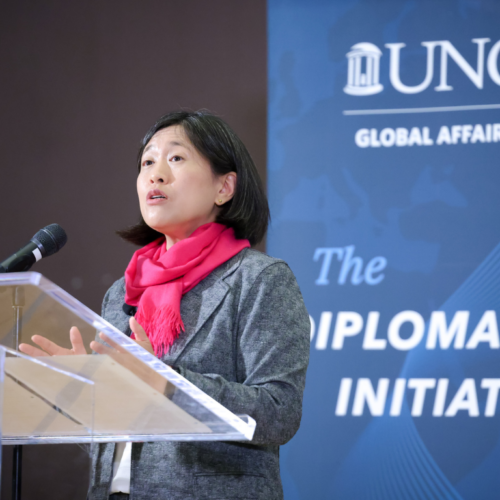 Ambassador Katherine Tai speaks at a UNC Global Affairs Diplomacy Initiative event behind a clear podium.