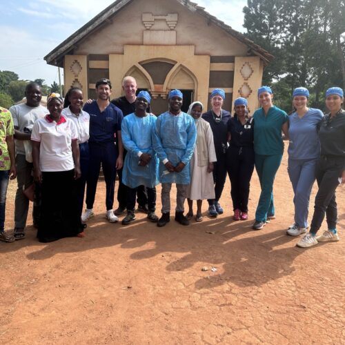 UNC dental students pose for a photo alongside locals during a service trip to Uganda.