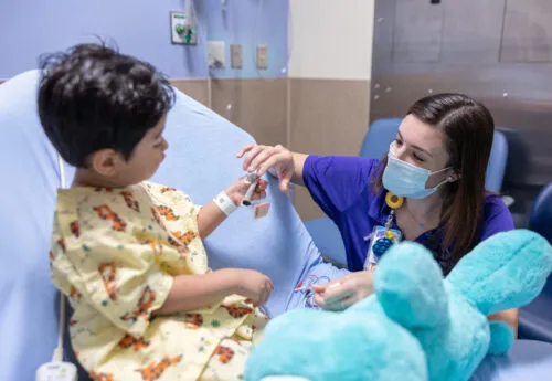 Healthcare worker treats young patient.