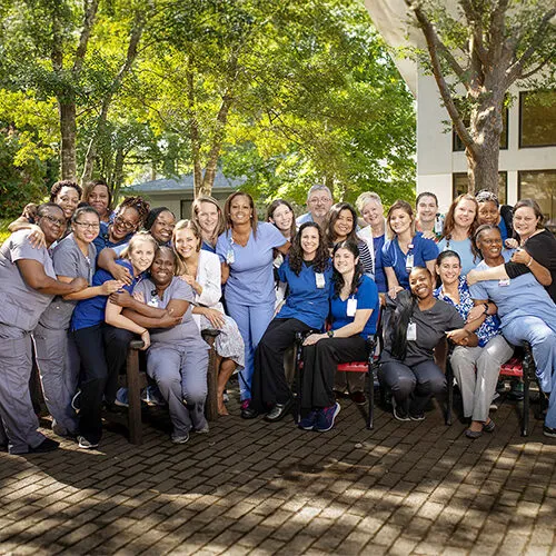 Rex staff smiling outdoors.