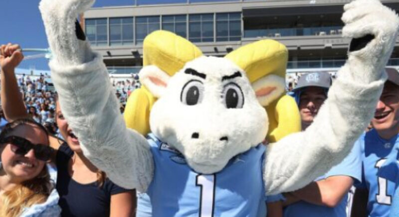 Ramses standing in front of students in the football stadium