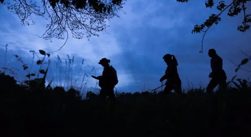 students hiking during dawn