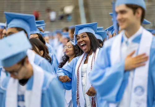Student smiles during commencement.