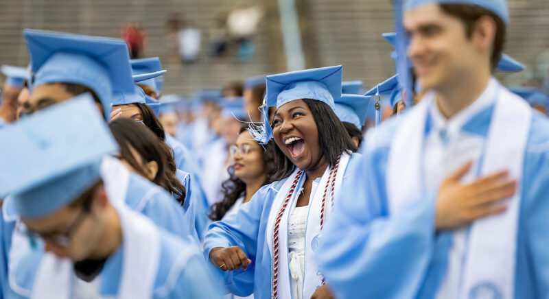 Student smiles during commencement.