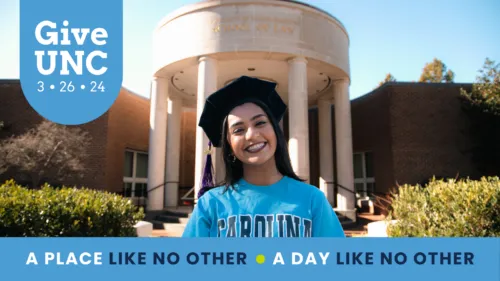 Law Student stands outside the building with graduation cap on.