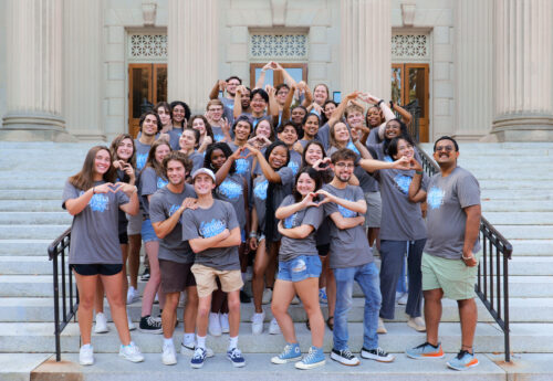 A group of Carolina Housing staff members pose for a photo wearing Carolina Housing t-shirts.