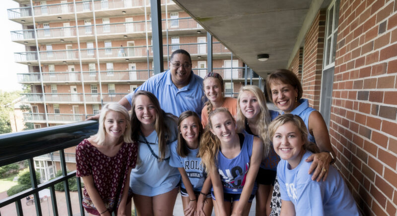 Group of Carolina Students posing in front of a dorm.