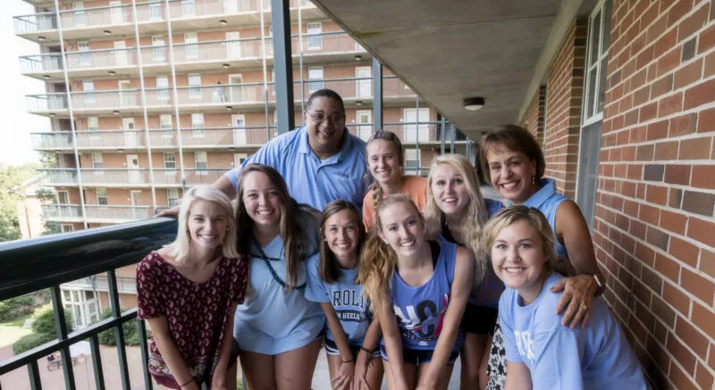 Group of Carolina Students posing in front of a dorm.