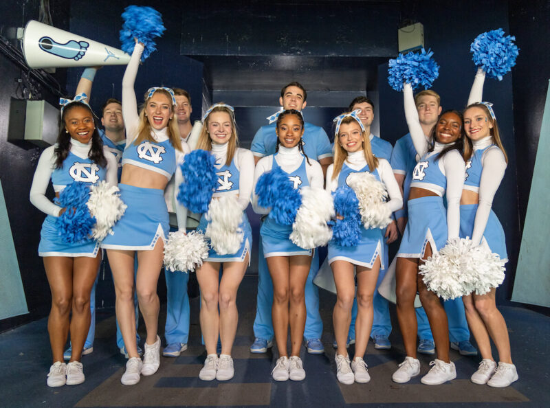 Carolina cheerleaders cheering in a tunnel leading to the Kenan Stadium football field