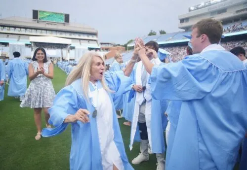 Students high-five at graduation