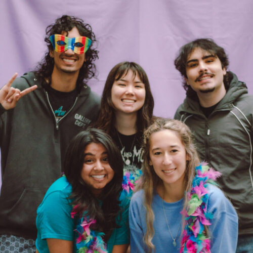 LGBTQ Grad Student Program. Students smile to camera.