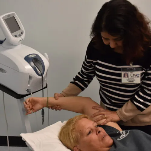 Medical professional exams a patient.